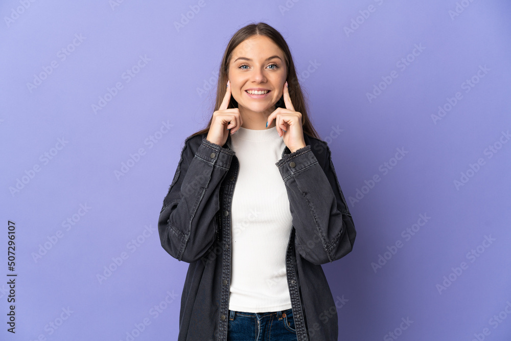 Young Lithuanian woman isolated on purple background smiling with a happy and pleasant expression Young Lithuanian woman isolated on purple background smiling with a happy and pleasant expression