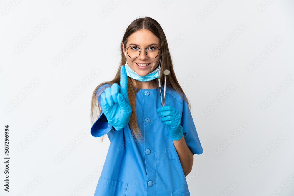 Lithuanian woman dentist holding tools over isolated background showing and lifting a finger Lithuanian woman dentist holding tools over isolated background showing and lifting a finger