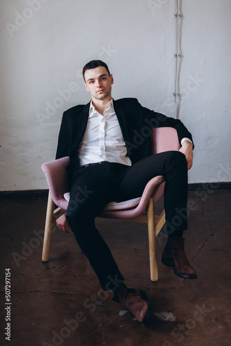 Handsome businessman in fashion suit alone in studio. Expressive young man concept © Andreshkova Nastya
