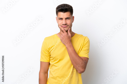 Young caucasian man isolated on white background thinking
