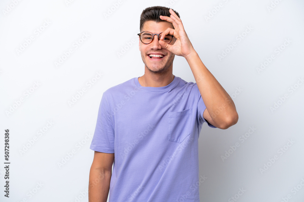 Fototapeta premium Young caucasian man isolated on white background showing ok sign with fingers