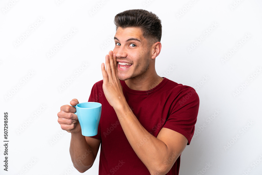 Young caucasian man holding cup of coffee isolated on white background whispering something Young caucasian man holding cup of coffee isolated on white background whispering something