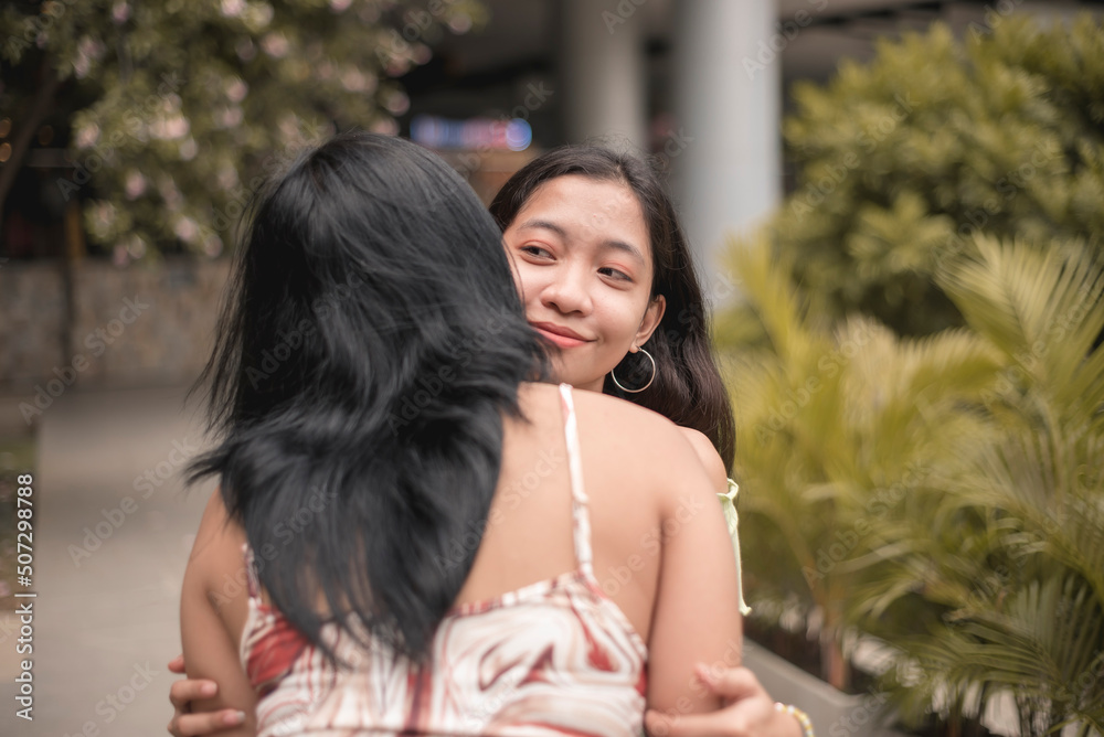 Foto de Two friends greet each other with besobeso, a common greeting