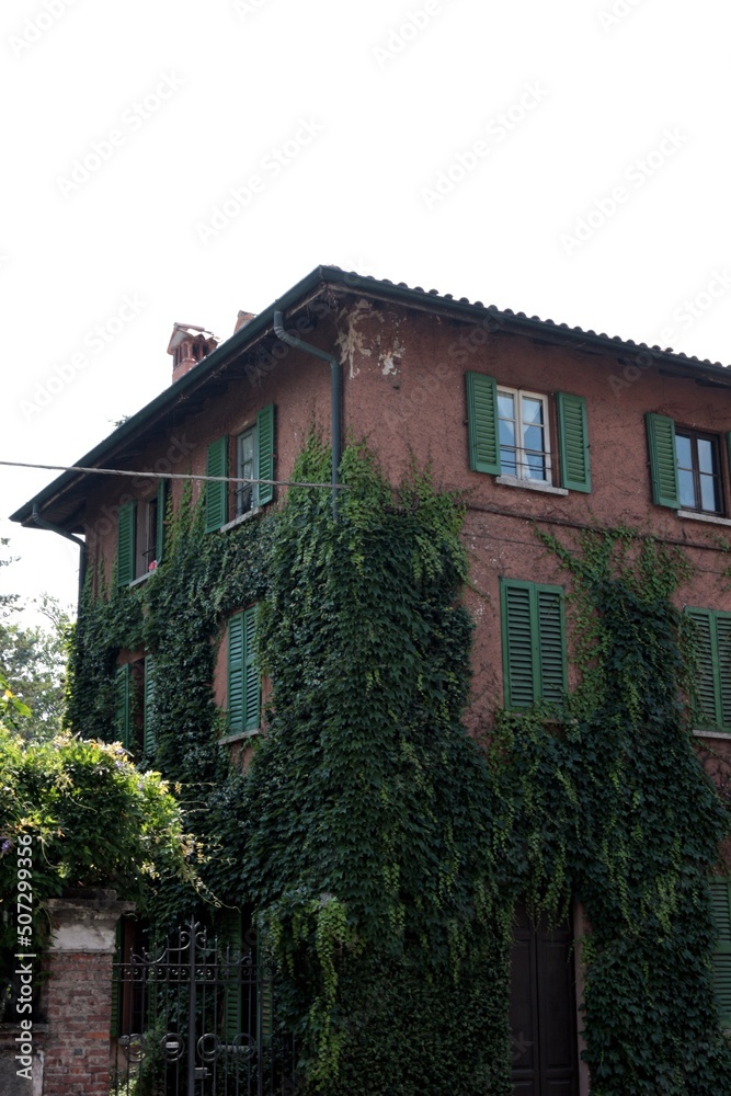 Italy, Lombardy: Old house with climbing plant.