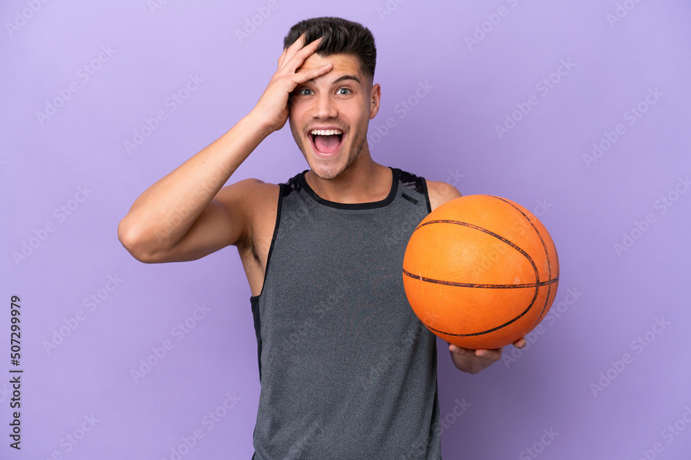 young caucasian woman  basketball player man isolated on purple background with surprise expression