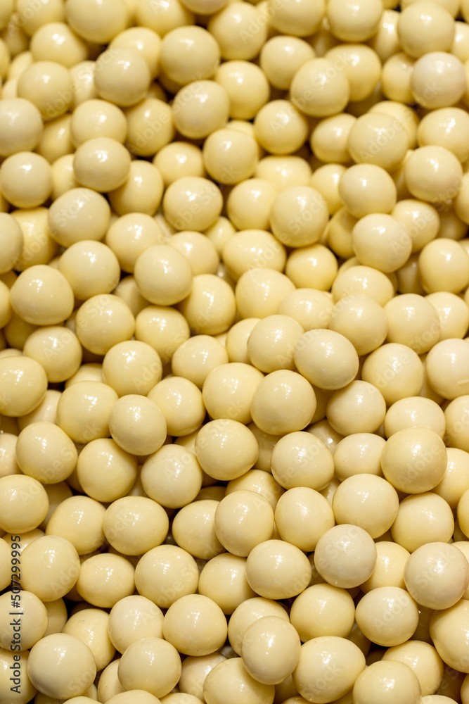 White chocolate dragee. Hazelnuts with white chocolate filling. Sweet snack. close up White chocolate dragee. Hazelnuts with white chocolate filling. Sweet snack. close up