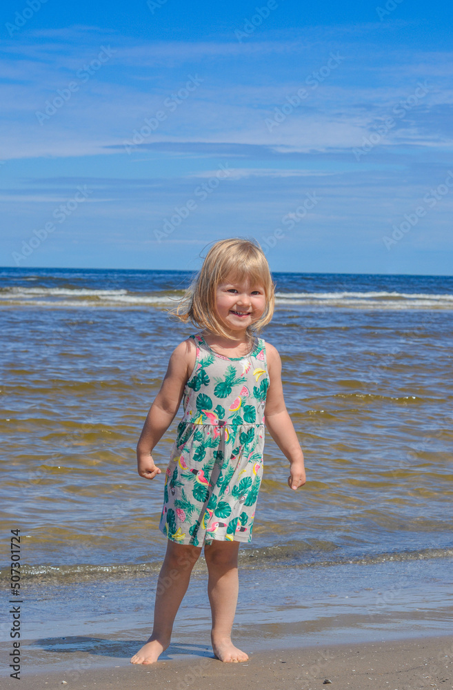 Happy child girl on the beach in summer sunny day Happy child girl on the beach in summer sunny day
