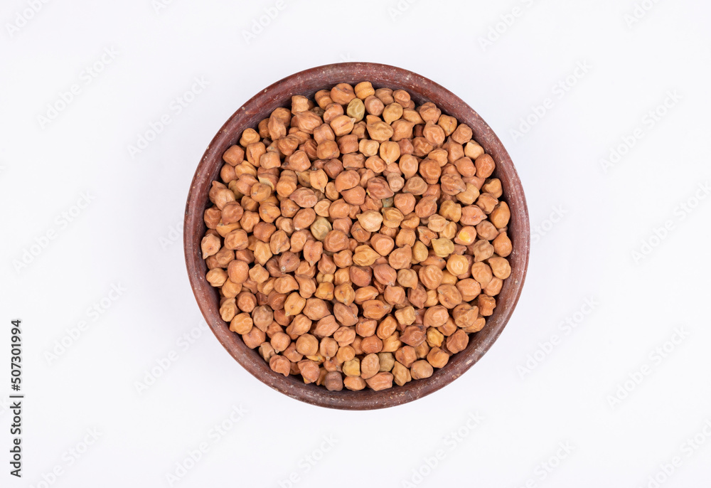 chickpeas (Bengal Gram) in rock bowl on white background. Close up of Organic chana or chickpea (Cicer arietinum). for design and banner. top view chickpeas. chickpeas (Bengal Gram) in rock bowl on white background. Close up of Organic chana or chickpea (Cicer arietinum). for design and banner. top view chickpeas.