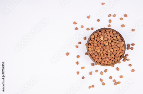 chickpeas (Bengal Gram) in rock bowl on white background. Close up of Organic chana or chickpea (Cicer arietinum). for design and banner. top view chickpeas.