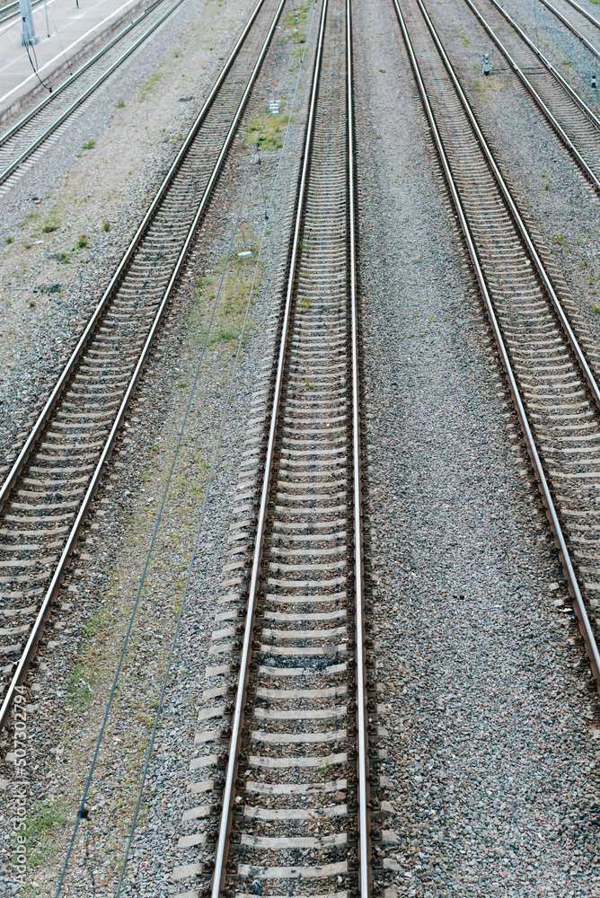 Empty railroad, iron rails and sleepers outdoors. Top view, perspective, vertical frame