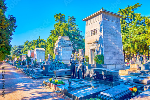 The funeral tombs and graves of Memorial Cemetery are decorated with outstanding sculptures and other art decorations, Milan, Italy photo