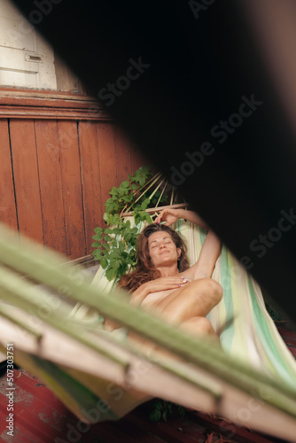 Girl in a hammock with fruits, relaxation in a hammock