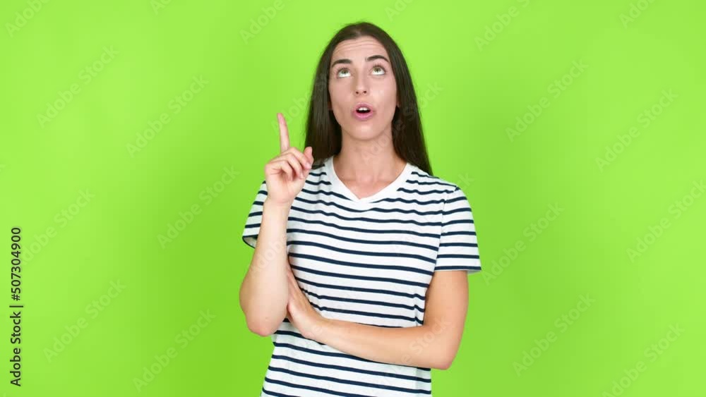 Young brunette woman standing and thinking an idea pointing the finger up over isolated background. Green screen chroma key Young brunette woman standing and thinking an idea pointing the finger up over isolated background. Green screen chroma key