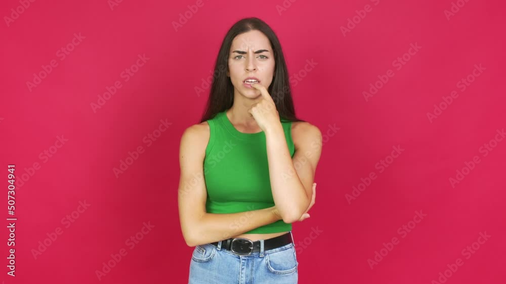Young brunette woman having doubts and questioning an idea over isolated background Young brunette woman having doubts and questioning an idea over isolated background