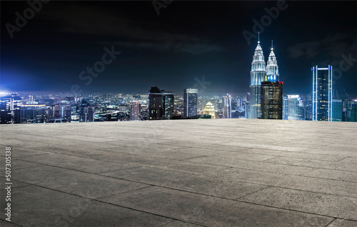 Photography Empty brick platform with kuala lumpur city skyline in background at night