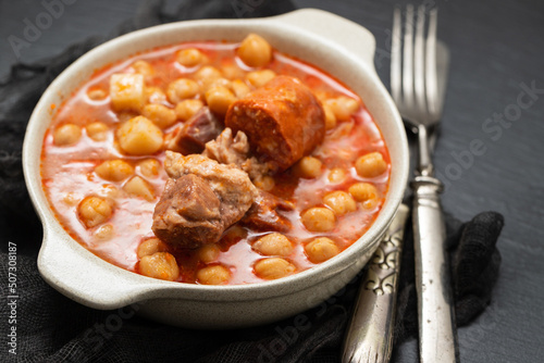 chick pea with smoked sausages in white bowl photo