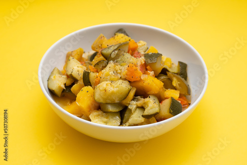 chick pea with smoked sausages in white bowl