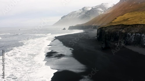 Wallpaper Mural Rocky Coast washed by ocean waves. Aerial view of a black beach mossy Mountains in Iceland. Untouched Arctic Nature. Torontodigital.ca