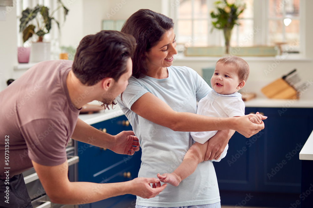 Fototapeta premium Loving Transgender Family With Baby In Kitchen At Home Together