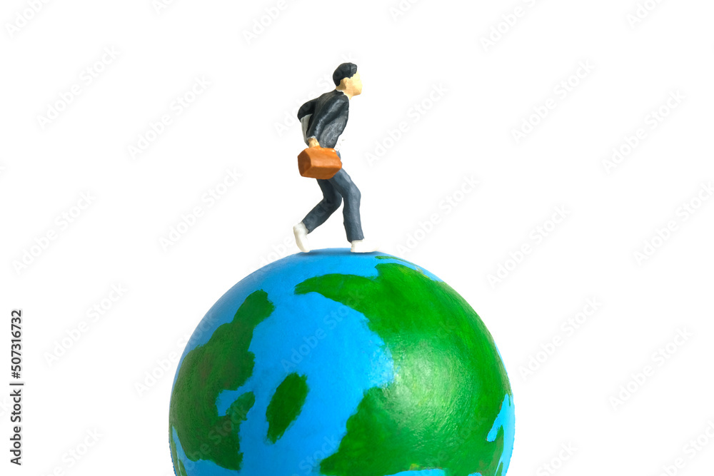 Miniature people toy figure photography. Study abroad and educational ceremony concept. A Young men pupil running above earth globe isolated on white background Miniature people toy figure photography. Study abroad and educational ceremony concept. A Young men pupil running above earth globe isolated on white background