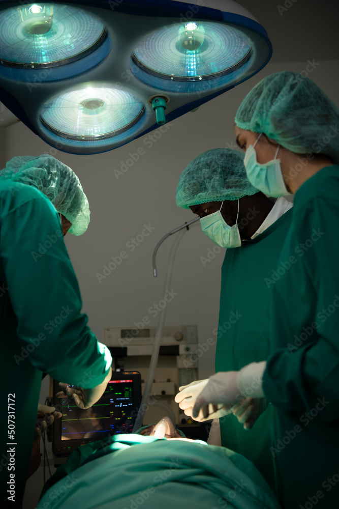 Professor of medicine in cardiology and a team of doctors in the operating room undergoing heart transplant surgery Professor of medicine in cardiology and a team of doctors in the operating room undergoing heart transplant surgery
