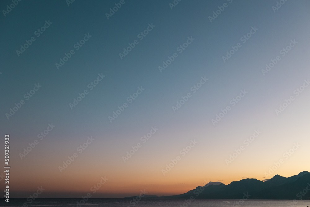Sea and mountains at sunset