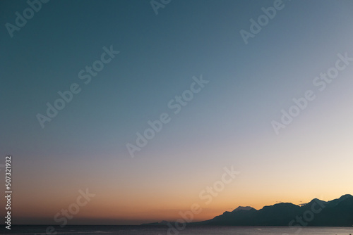 Sea and mountains at sunset © zhukovvvlad