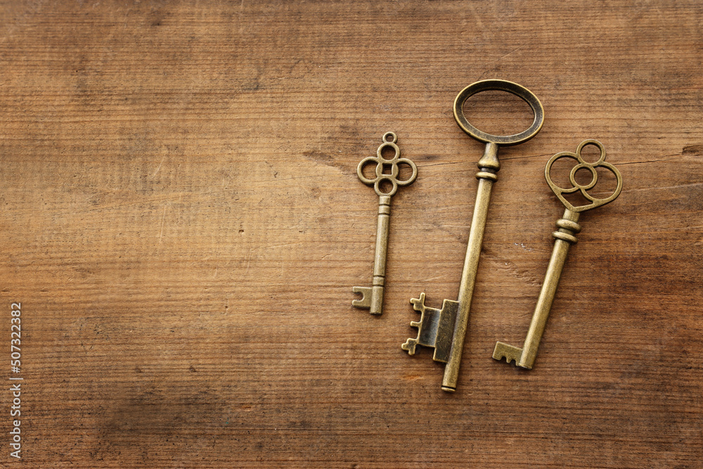 Top view image of old keys over wooden background