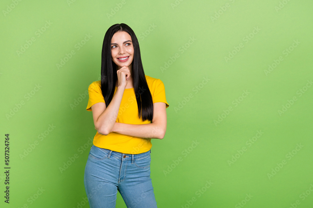 Photo of charming thoughtful lady dressed yellow t-shirt arm chin looking empty space isolated green color background Photo of charming thoughtful lady dressed yellow t-shirt arm chin looking empty space isolated green color background