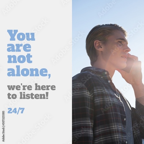Digital composite image of caucasian young man speaking on phone with you are not alone text