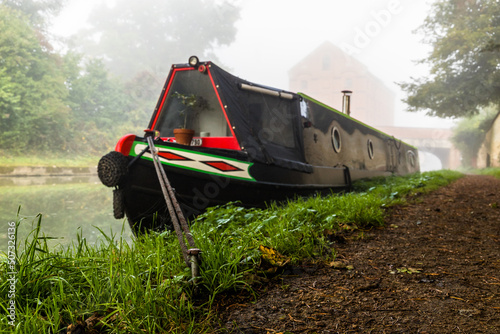 Obraz na plátně Moored narrow boat in the mist.