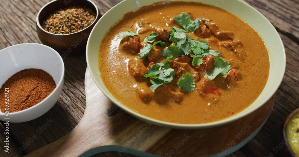 Video of freshly prepared curry in bowl lying on board on wooden surface Video of freshly prepared curry in bowl lying on board on wooden surface