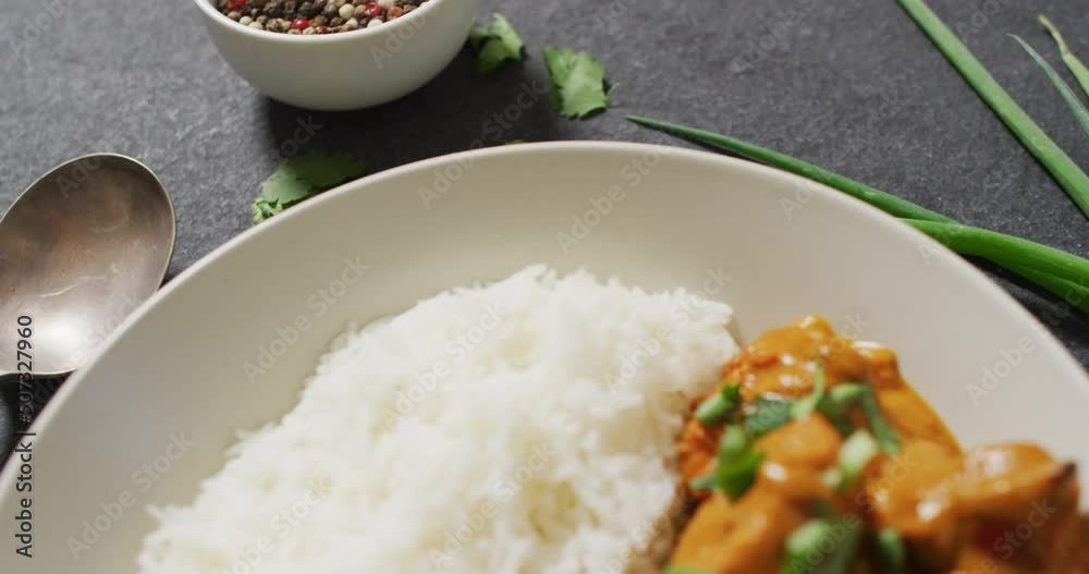 Video of plate with rice and curry lying in grey background Video of plate with rice and curry lying in grey background