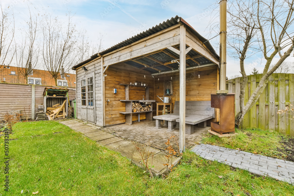Wooden house yard with fireplace in countryside Wooden house yard with fireplace in countryside