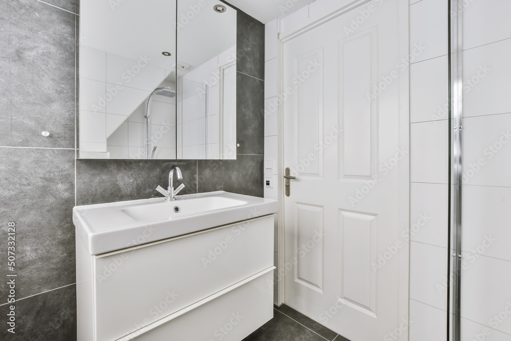 Contemporary bathroom interior with ceramic sink and mirror cabinet