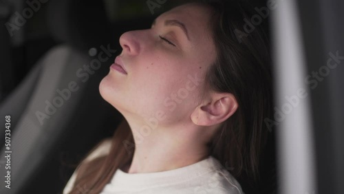 The female driver is sleeping in the car. Chronic fatigue, work in a taxi 4K 10 BIT