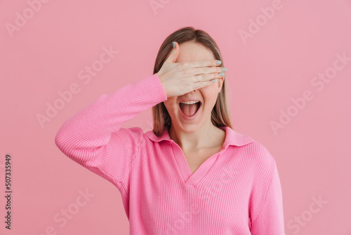 Young beautiful white woman wearing shirt smiling and covering eyes © Drobot Dean