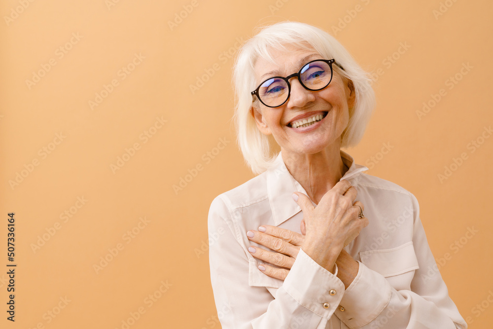 Beautiful smiling senior woman with folded arms on her chest Beautiful smiling senior woman with folded arms on her chest