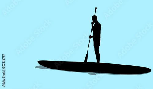 Silhouette of young man standing on sup board floating in sea in sunny day. Tourist learning to paddle and balance on paddle board.