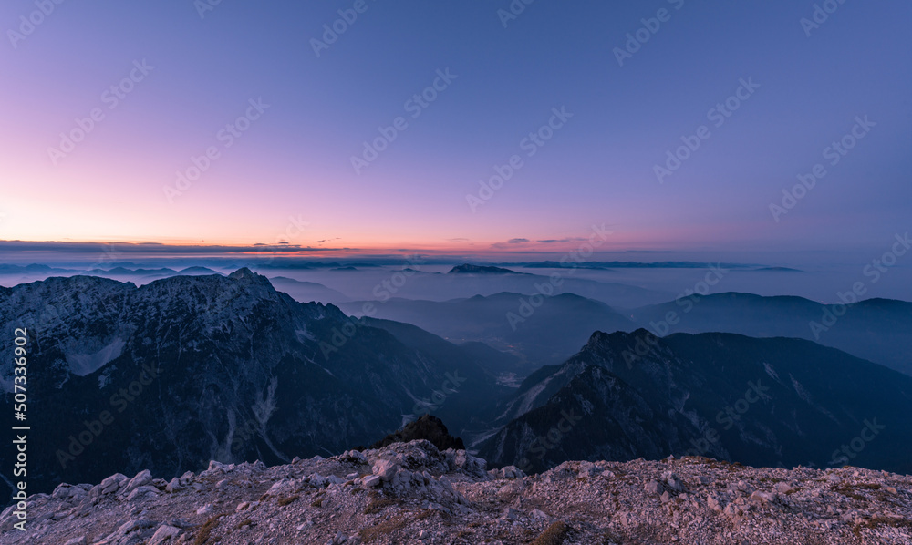 Hiking in the vast landscape of Julian Alps. Photograph was taken from the top of Mojstrovka mountain at sunset.
