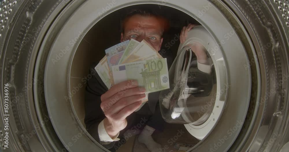 Man shows money in the washing machine. European euro banknotes. Rise in price of water and electricity, cost of utility bills. Man shows money in the washing machine. European euro banknotes. Rise in price of water and electricity, cost of utility bills.