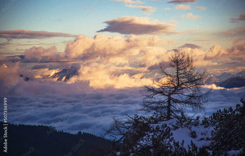 Fog under the mountains at sunset Fog under the mountains at sunset