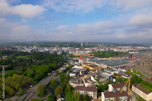Aerial view of City of Basel with highway and railway track field on a blue cloudy spring day. Photo taken April 27th, 2022, Basel, Switzerland.