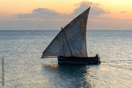 large african sailing dhow on the ocean with a distant blue horizon