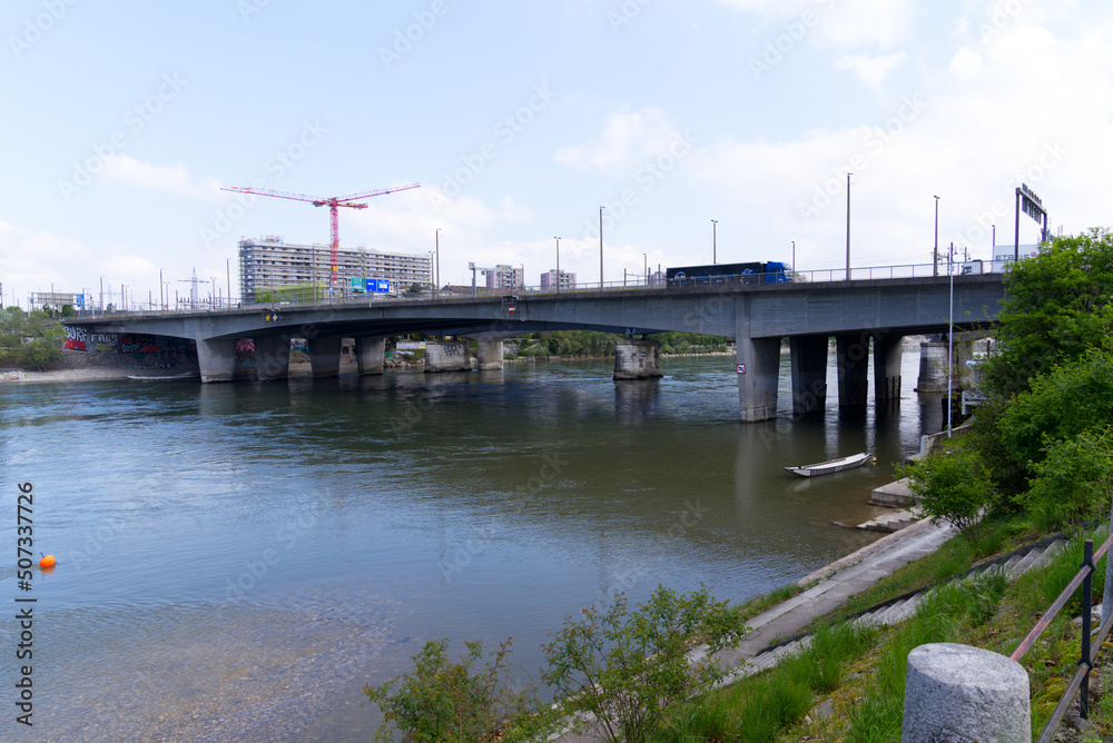 Scenic landscape with Rhine River at City of Basel on a blue cloudy spring day with Schwarzwald Bridge in the Background. Photo taken April 27th, 2022, Basel, Switzerland.