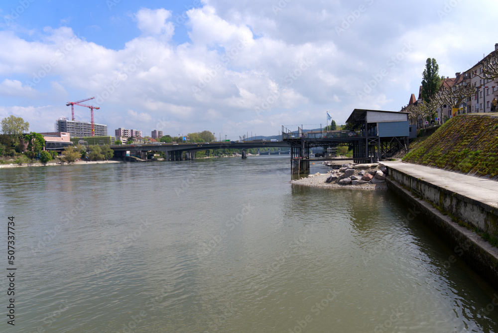 Scenic landscape with Rhine River at City of Basel on a blue cloudy spring day with Schwarzwald Bridge in the Background. Photo taken April 27th, 2022, Basel, Switzerland.