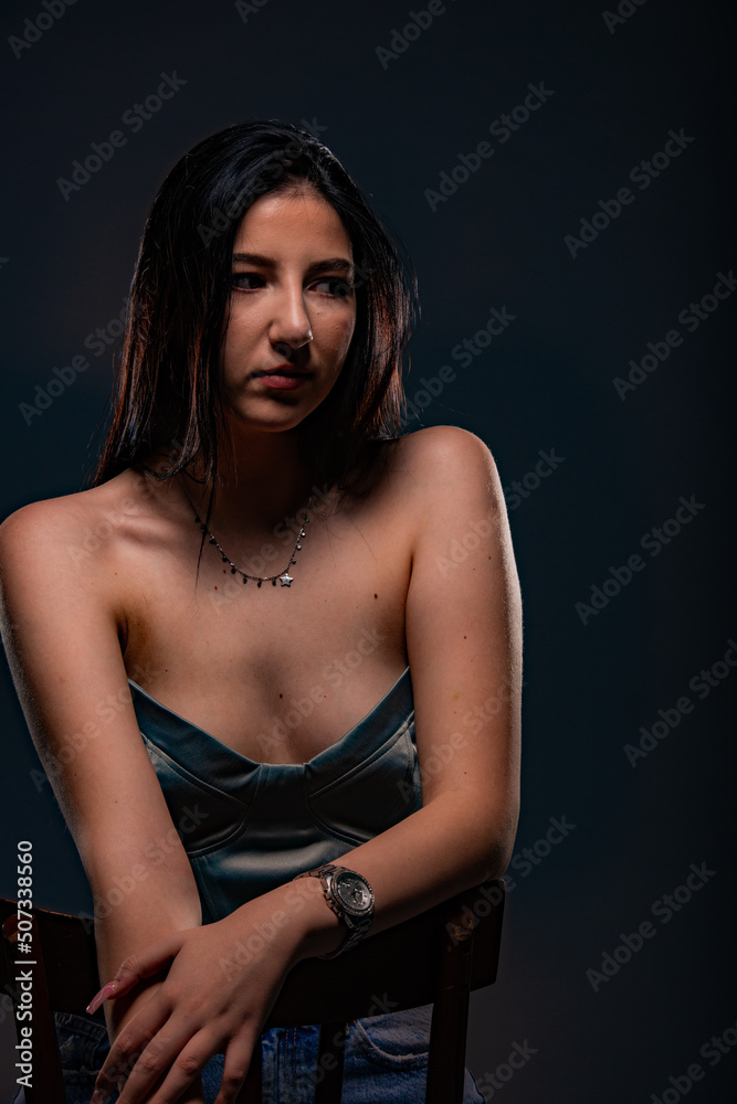 Posing and sitting on the chair while looking around Posing and sitting on the chair while looking around