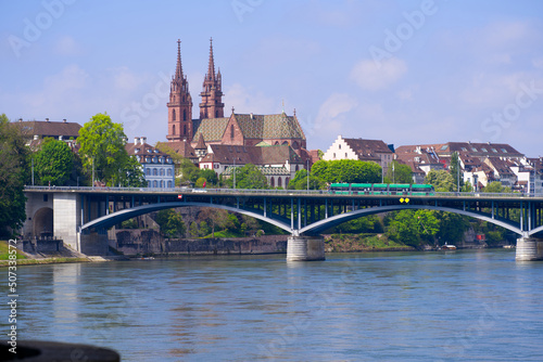 Skyline of the old town of Basel with Basler Minster and Wettstein Bridge in the foreground on a blue cloud spring day. Photo taken April 27th, 2022, Basel, Switzerland.