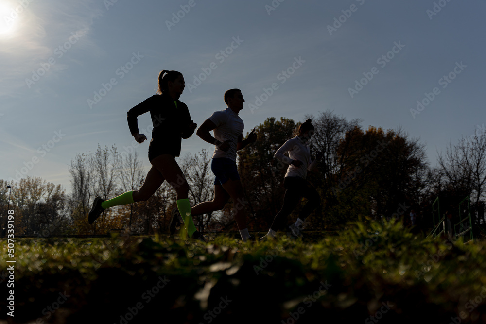 Silhouettes running outside Silhouettes running outside