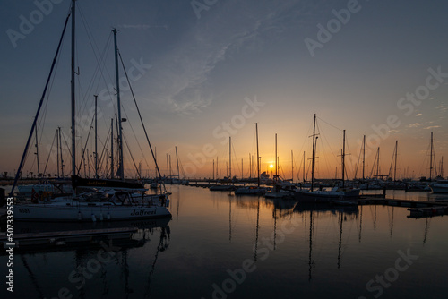 ships moored in the port of la linea de la concepcion in front of gibraltar at sunset © Daniel